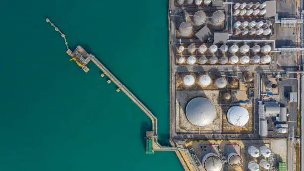 Photo of Aerial view of tank terminal with lots of oil storage tank and petrochemical storage tank in the harbour, Industrial tank storage aerial view.