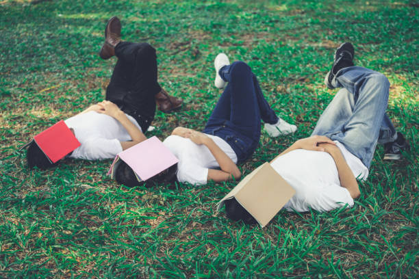 istock Funny students sleeping with books on their face. 1165972092