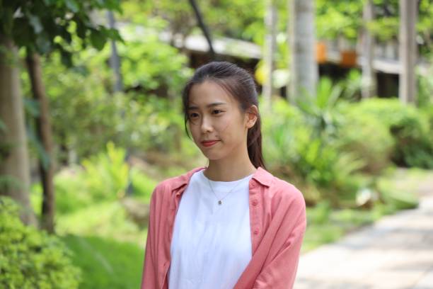 istock Beautiful young female in public park 1165973823