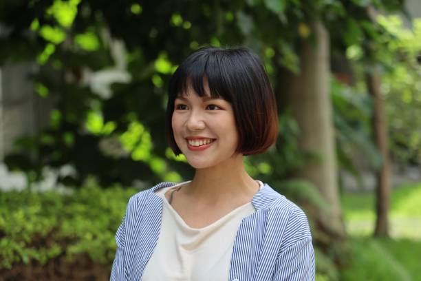 istock Beautiful young female in public park 1165973898