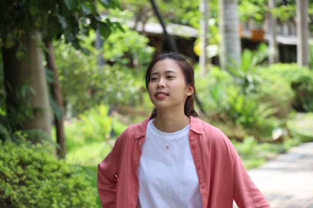 istock Beautiful young female in public park 1165973918