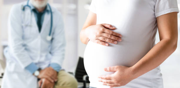 Pregnant Woman and Gynecologist Doctor at Hospital stock photo