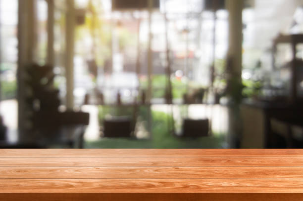 istock Wood table in blur background of modern restaurant 1165980635