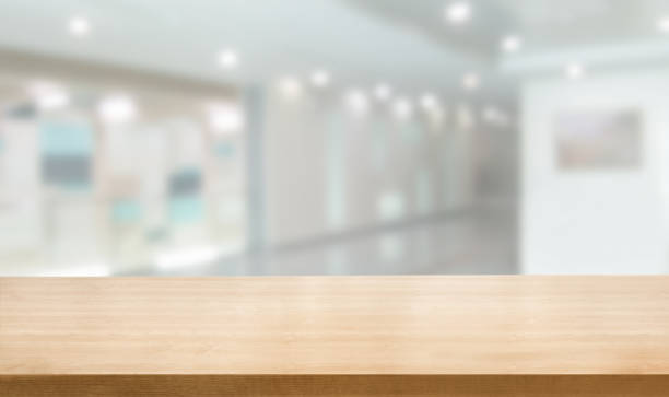 istock Wood table in modern hospital building interior. 1165980779