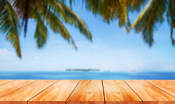 istock Brown wood table on summer tropical beach. 1165980803