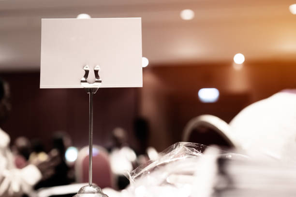 istock Mock up white Label for blank menu frame in seminar room or conference hall light on desk groups for letter, Event Background. Business Talk Presentation. 1165980807