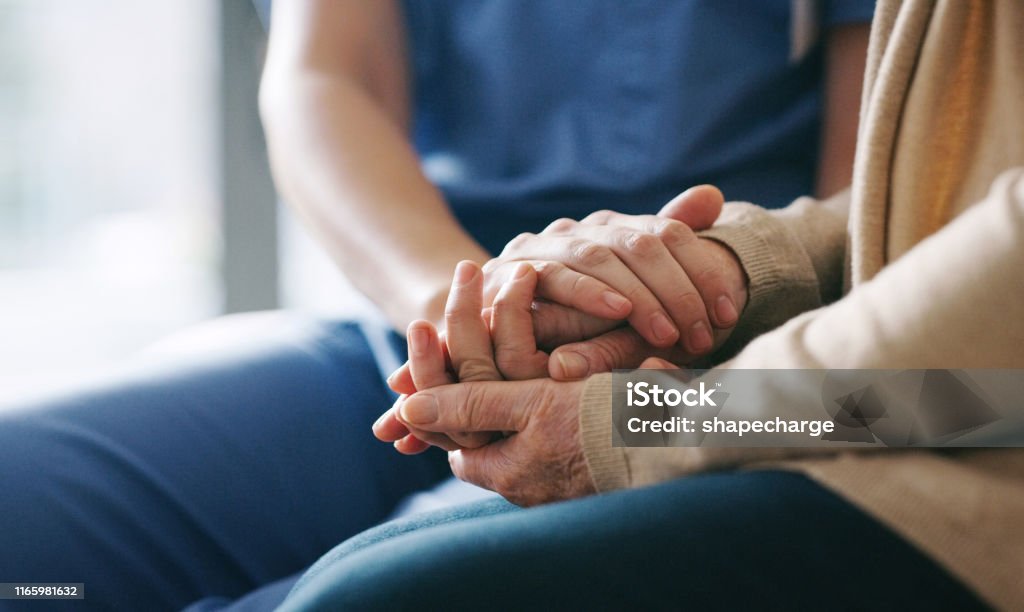 You're in a safe space now Cropped shot of a senior woman holding hands with a nurse Senior Adult Stock Photo