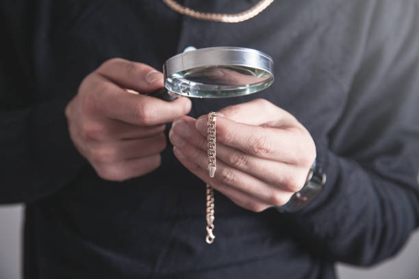 istock Jewelry holding magnifying glass with a bracelet. 1165983255