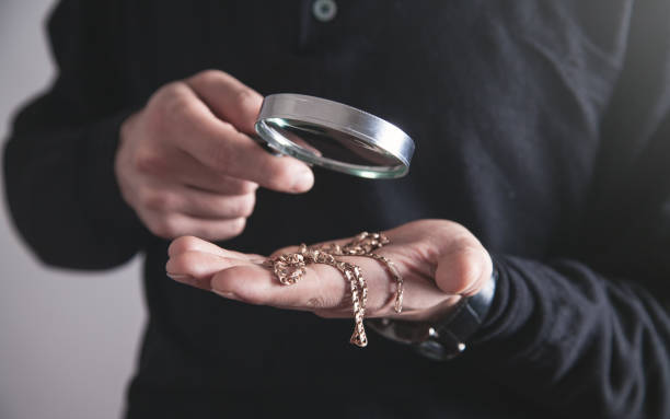 Jewelry holding magnifying glass with a bracelet. stock photo