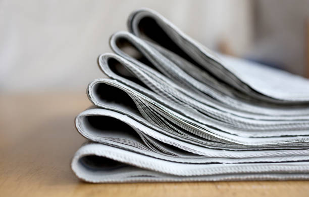 Pile of fresh morning newspapers on the table