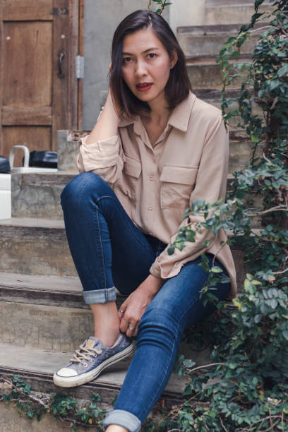 istock The woman sat at the old staircase 1165985049