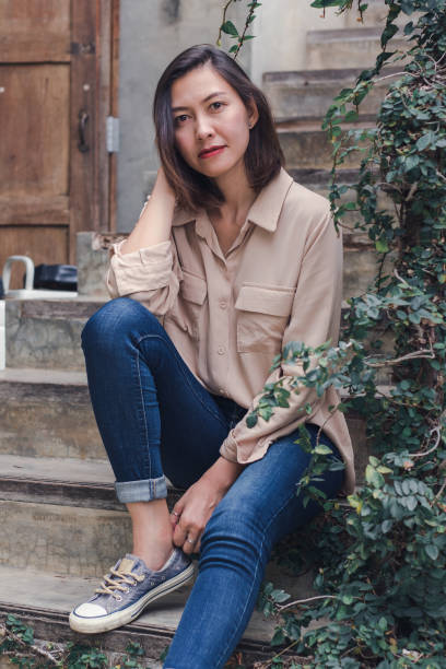 istock The woman sat at the old staircase 1165985989