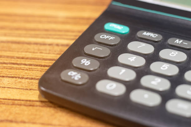 istock Close up calculator on wooden table with copy space for text on the left. Finances business savings and accounting concept or Education idea. 1165988997