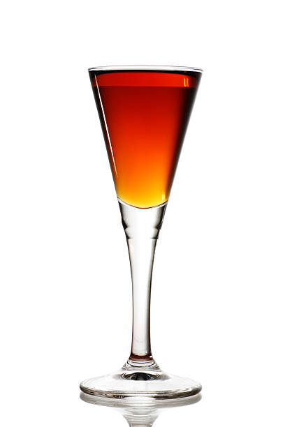 Beverage in a tall flute glass sitting on a white surface elegant cocktail glass with beverage sherry stock pictures, royalty-free photos & images