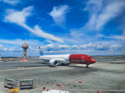 Rome, Italy - April 8 2019:  One Norwegian Airline Airplane is on the runway at Leonardo Da Vinci Fiumicino airport.  Voted for 5 years by passengers in the SkyTrax World Airline Awards as the world's best long haul, low-cost Airline.