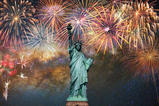 Statue of Liberty over the Multicolor Fireworks Celebrate with the milky way background, 4th of July and Independence day concept stock photo