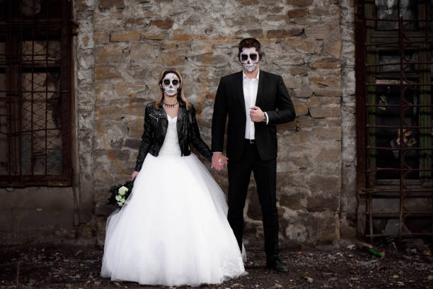 istock Halloween couple. Dressed in wedding clothes romantic zombie 1165995994