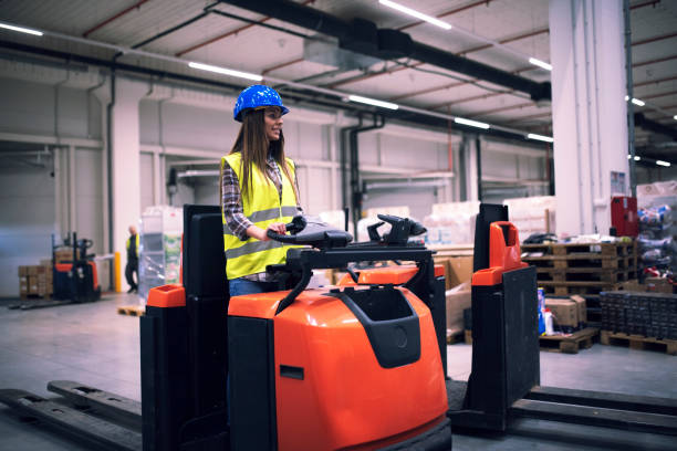istock Industrial worker driving forklift in factory. 1165997364
