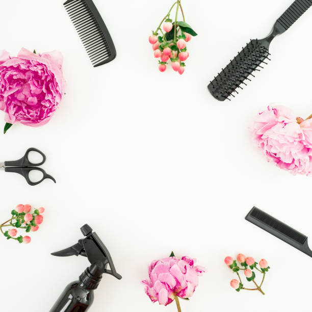 istock Hairdresser composition frame with spray, scissors, combs and peonies flowers on white background. Flat lay, top view 1165999002