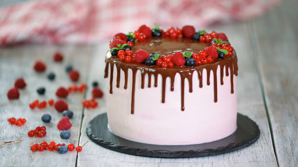 istock Cake with chocolate and summer berries on a white background 1165999876
