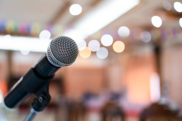 istock Seminar Conference Concept : Microphones for speech or speaking in seminar conference hall, prepare for talking lecture to audience university. Business meeting or education teaching iimage 1166000813