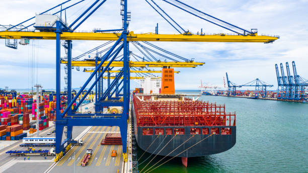 istock Aerial view cargo ship terminal, Unloading crane of cargo ship terminal, Aerial view industrial port with containers and container ship. 1166002080