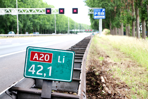 Speed and distancee sign at motorway A20 at 42,1 left where speed is in kilometers with red crosses above driving lanes