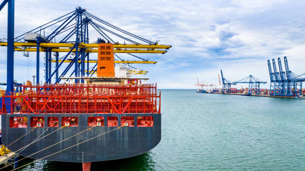 istock Aerial view cargo ship terminal, Unloading crane of cargo ship terminal, Aerial view industrial port with containers and container ship. 1166004285