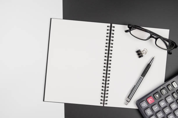 istock Top view of  blank notebook and pencil on black and white background 1166005972