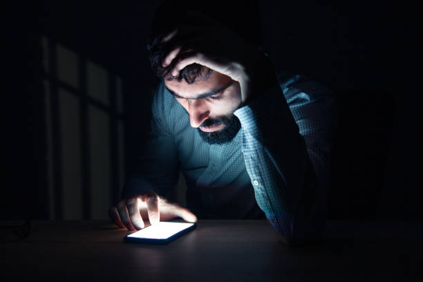 istock man hand phone at the dark room 1166011049