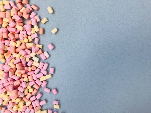 istock Pink, yellow and coral marshmallow on grey blue background . 1166011664
