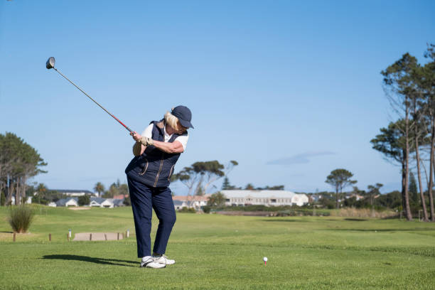 istock Elderly woman taking a golf shot in green course 1166012805