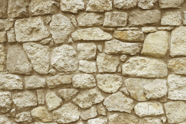 istock Beige stone mosaic wall background 1166013629