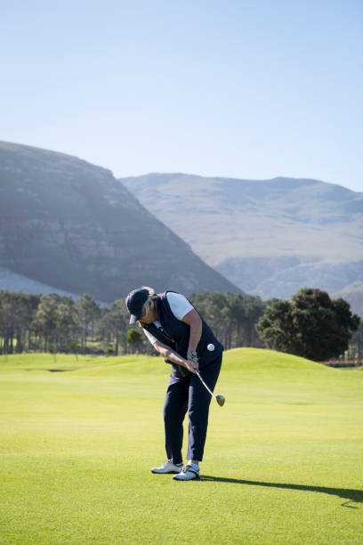 istock Senior female hitting a chip shot on the golf course 1166013798