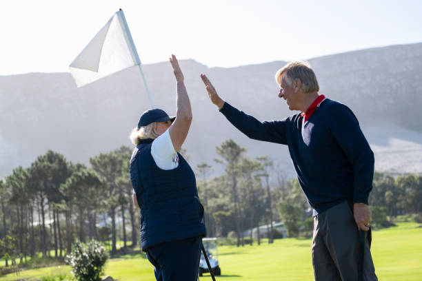 istock Couple celebrating winning shot with high five 1166013815
