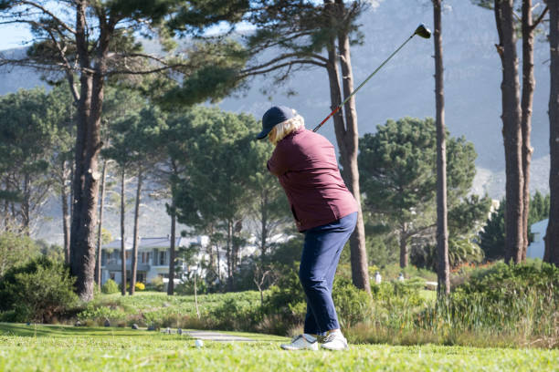 istock Elderly woman hitting golf ball from the t-box 1166013818