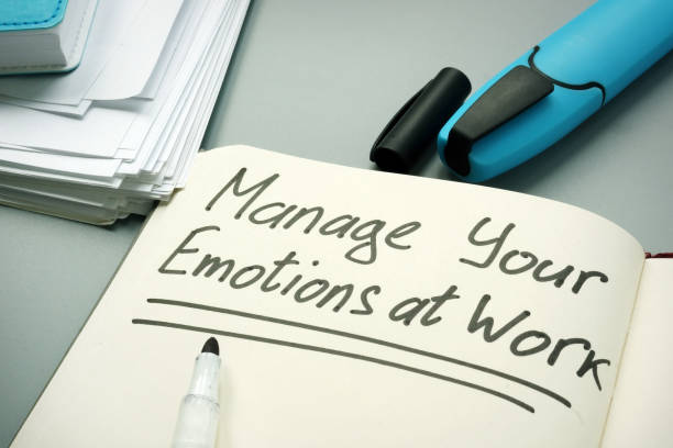istock Manage your emotions at work handwritten on a page. 1166014460