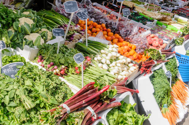 Salad vegetables, cauliflower and herbs for sale at a Danish market stall.