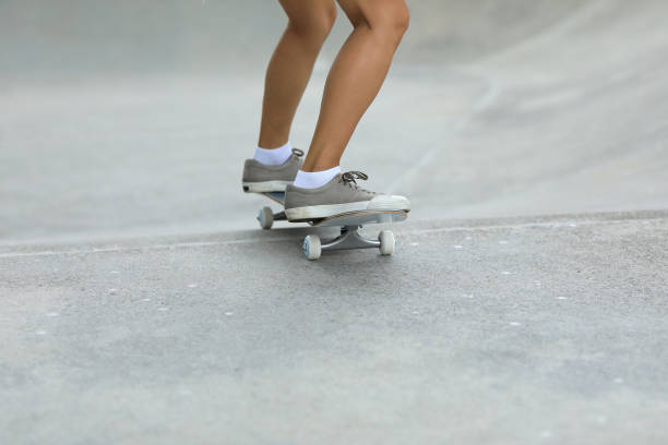 istock Female skateboarder skateboarding at skatepark 1166015775
