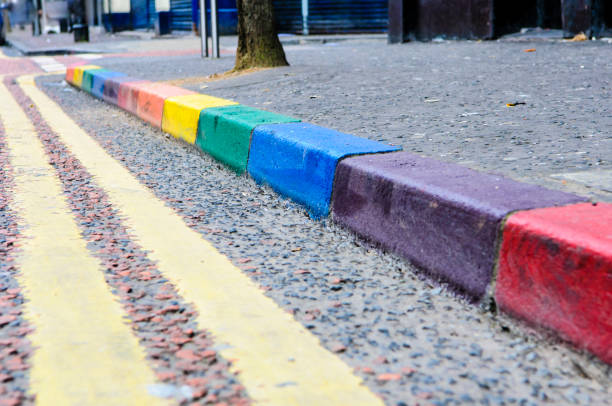 Rainbow colours painted on kerbstones in the gay area in Belfast. Rainbow colours painted on kerbstones in the gay area in Belfast. kerbstone stock pictures, royalty-free photos & images