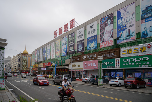 MISHAN, CHINA - JULY 27, 2019: People in commercial shopping street in Mishan. Mishan is a county-level city in the southeast of Heilongjiang
