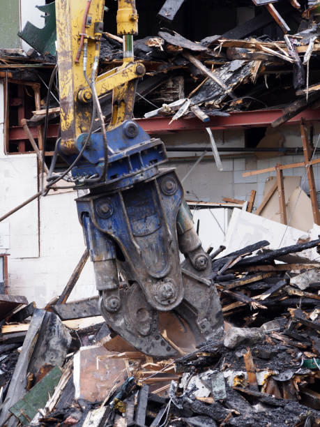 istock a demolition claw removing debris and rubble from a wrecked building damaged by fire 1166017763