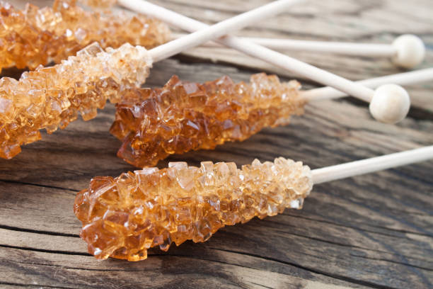 Sugar in a bamboo bowl on black backound