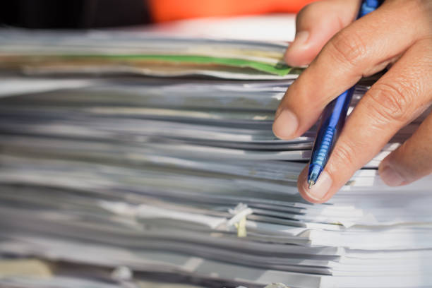 istock Accountant Business man Manager checking and signing applicant filling documents reports papers company application form on desk office. Document Report and business busy Concept 1166019205