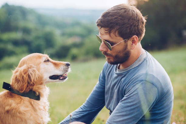 istock Happy man outdoors with his dog 1166022164