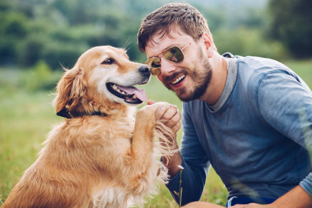 istock Happy man outdoors with his dog 1166025297