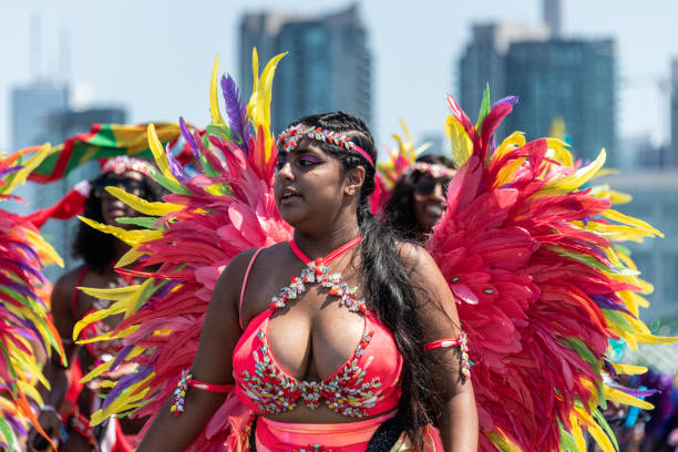 Toronto Caribbean Carnival or Caribana, Canada Toronto, Ontario, Canada-August 3, 2019: Close up of a female Afro Caribbean dancer with a multi-color costume. The Toronto Caribbean Carnival or Caribana is one of the largest street festivals in North America and it attracts thousands of tourists every year leaving about half a million dollars to the economy of Toronto city. exhibition place toronto stock pictures, royalty-free photos & images