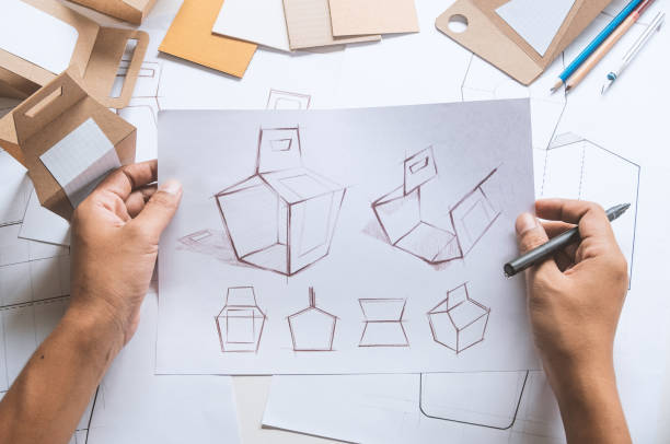 istock Designer sketching drawing design Brown craft cardboard paper product eco packaging mockup box development template package branding Label . designer studio concept . 1166026743