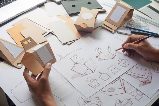 istock Designer sketching drawing design Brown craft cardboard paper product eco packaging mockup box development template package branding Label . designer studio concept . 1166026749