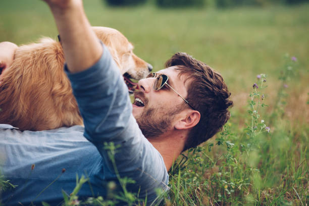istock Happy man outdoors with his dog 1166027667